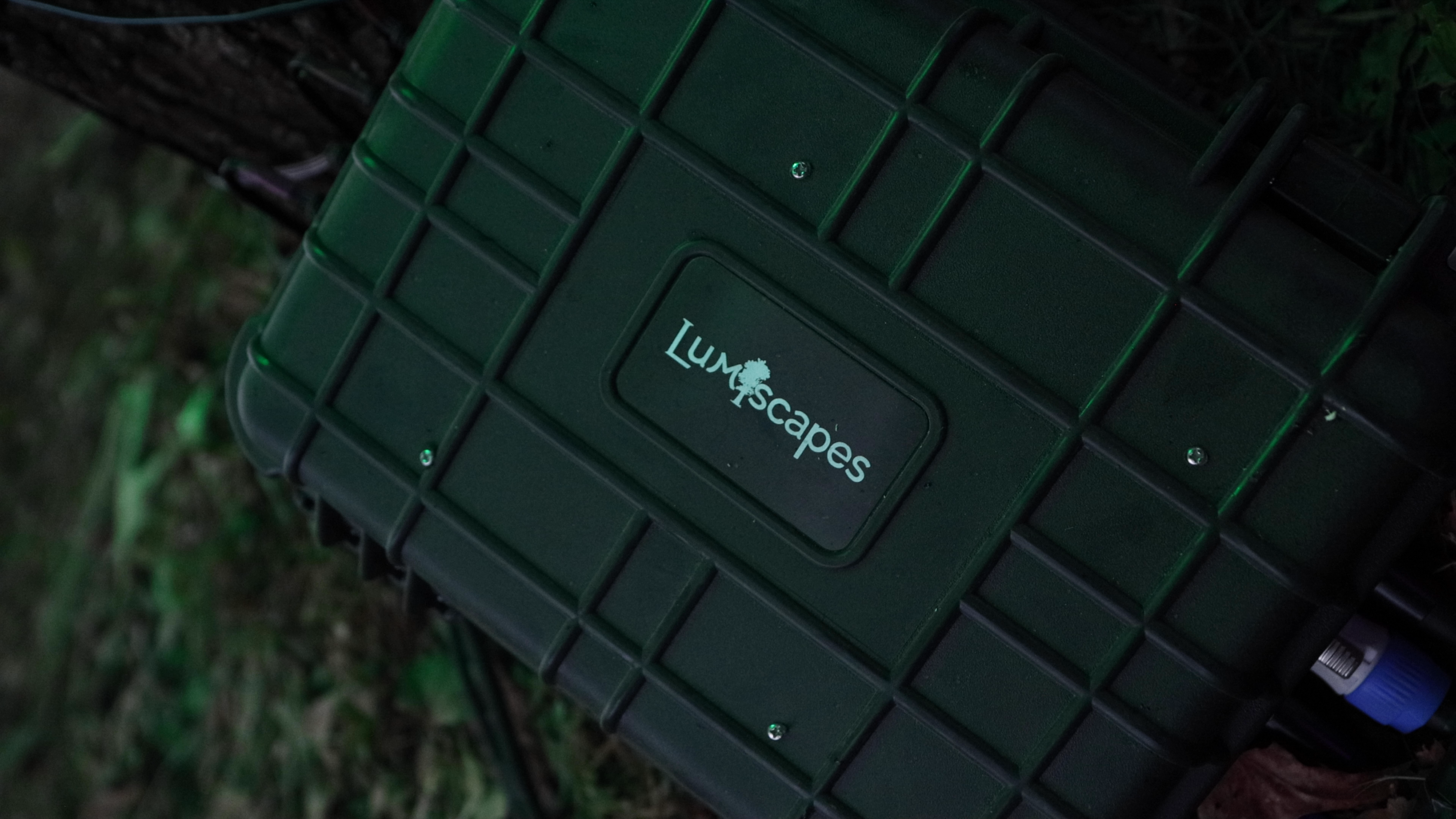 Green Lumenscapes equipment case on the ground.